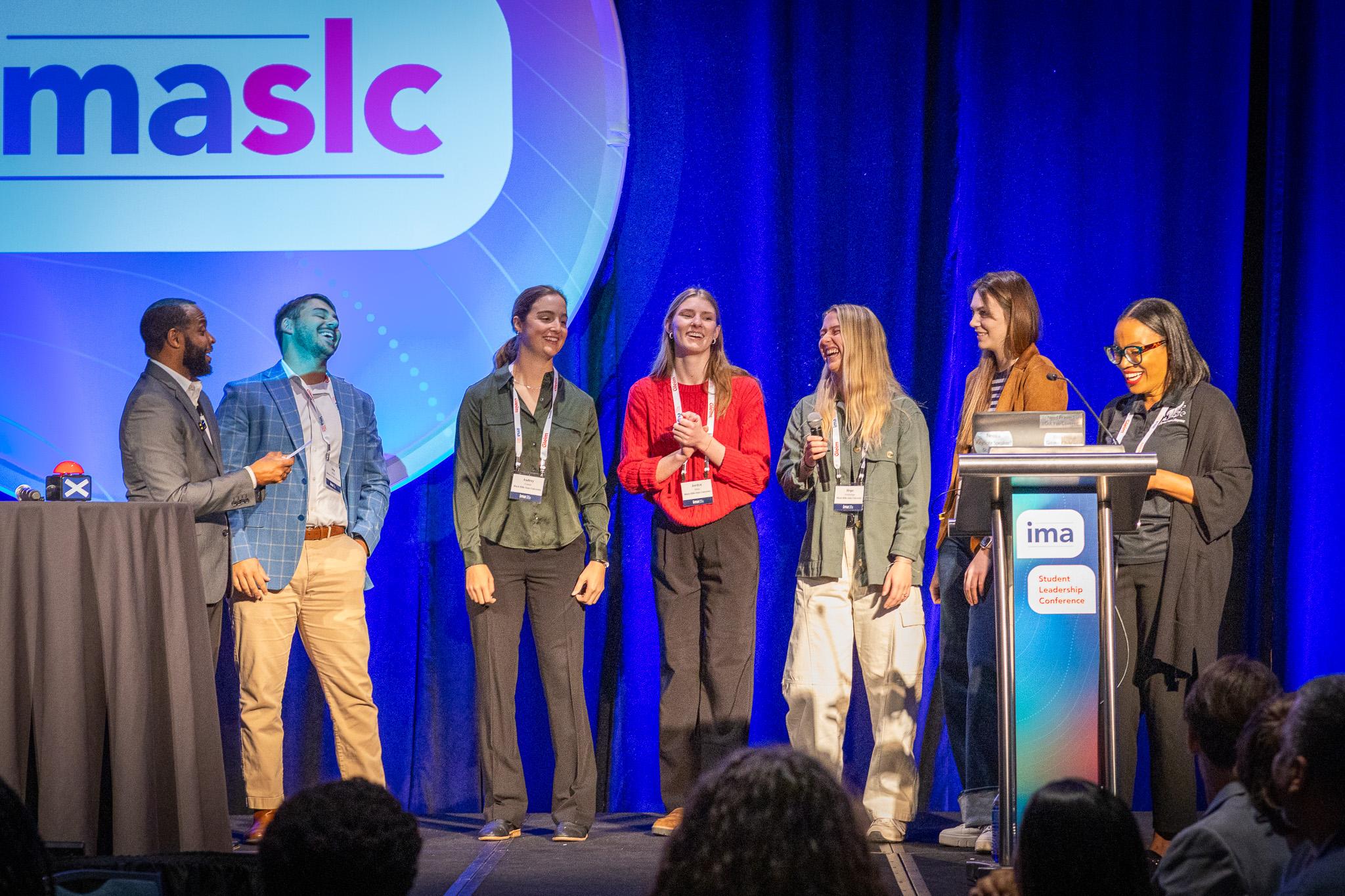 Image of students laughing on stage